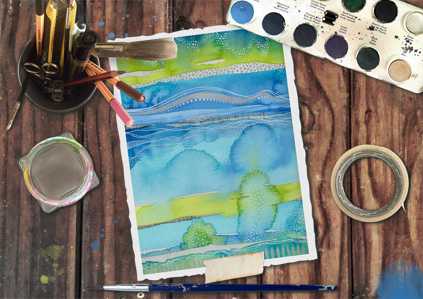 this is an image of a painting by joanne grant art.  This painting is blue and teal and lime green.  It is an abstract landscape painted with watercolor paints.  The painting is laying on a brown desk with art supplies surrounding it.  The art supplies are masking tape, which is to the right, a jar of water to the left of the painting, a paint brush below the painting, a can of pencils, pens, extra paint brushes and scissors and to the top left is a watercolor pan with paints in it.