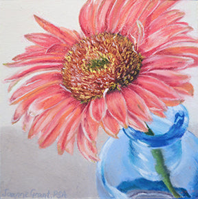 Zinnia with blue glass is a pastel painting by joanne grant.  It is a square painting with a blue glass bottle in the bottom right corner.  Coming out of the bottle is a pink zinnia flower.  The flower is very detailed with the texture of the petals and the center.  